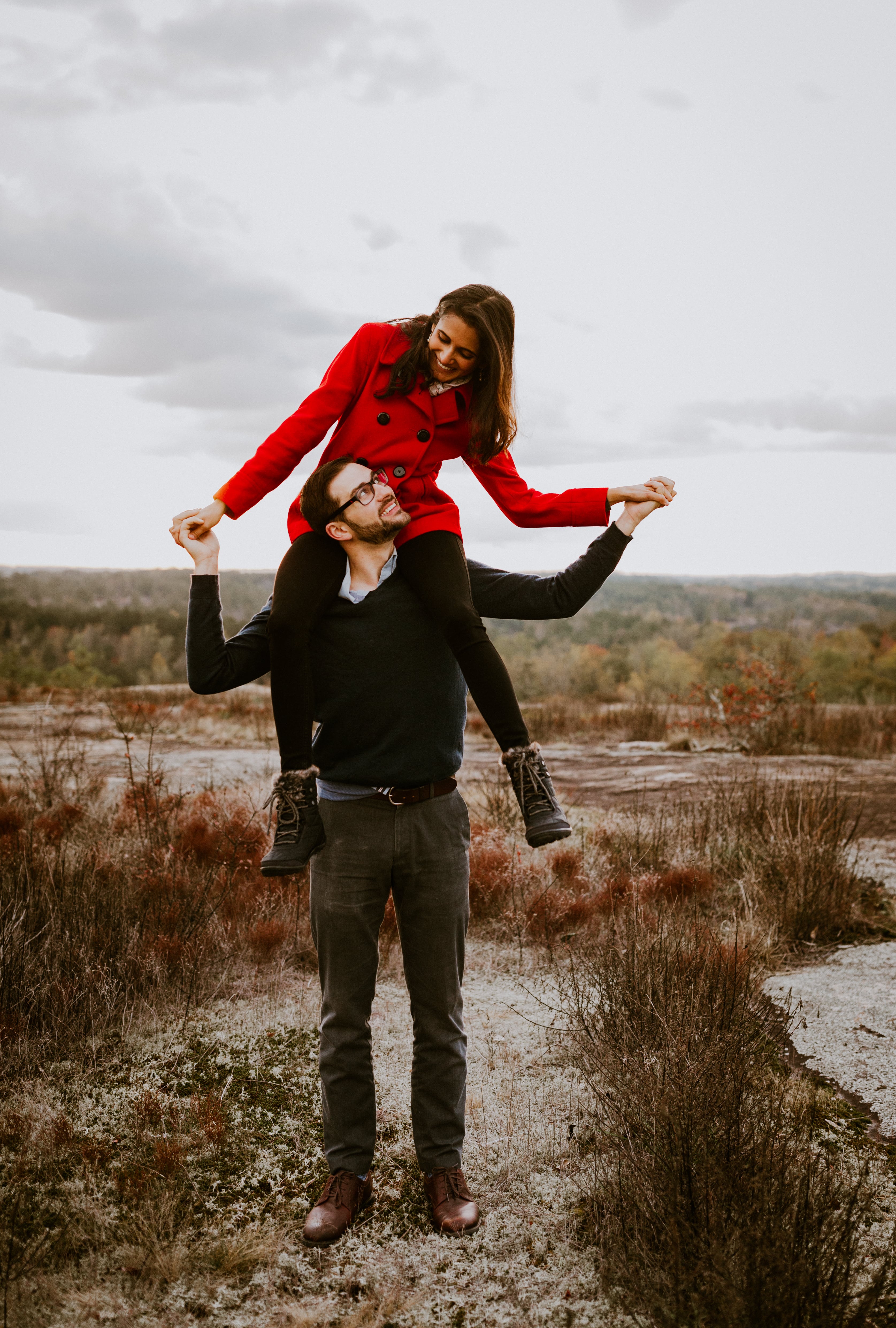 Sharvari sitting on Logan's shoulders, both looking happy.